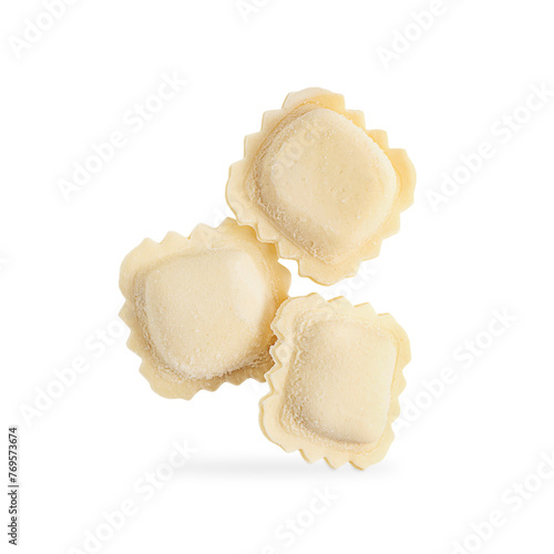 Three uncooked frozen homemade italian ravioli type of pasta made with dough stuffed with ricotta cheese of square shape levitating or flying isolated on white background used for traditional dinner