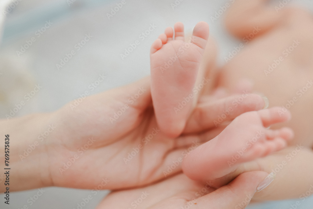 Tender Newborn Toes. A heartwarming close-up of a parent cradling their baby’s delicate feet, radiating love and connection Tender Newborn Toes. A heartwarming close-up of a parent cradling their baby’s delicate feet, radiating love and connection