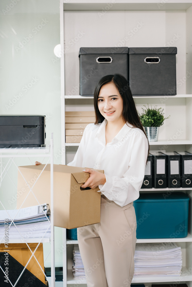 Happy and excited young beautiful Asian woman office worker celebrating her resignation, carrying her personal stuff. leaving job, changing or company. Happy and excited young beautiful Asian woman office worker celebrating her resignation, carrying her personal stuff. leaving job, changing or company.