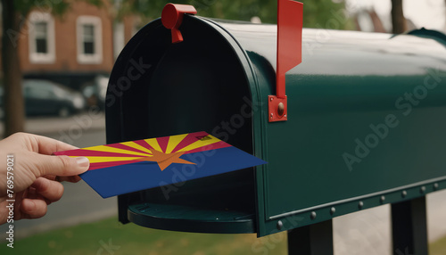 Close-up of person putting on letters with flag Arizona in mailbox