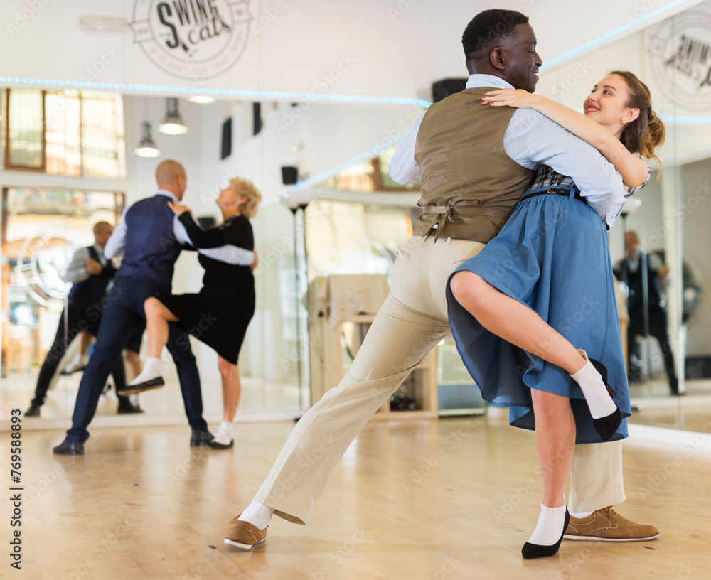 Woman with american man practising ballroom dancing Woman with american man practising ballroom dancing