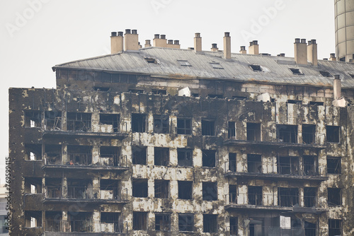 The exterior of a completely burned down apartment building after a fire photo