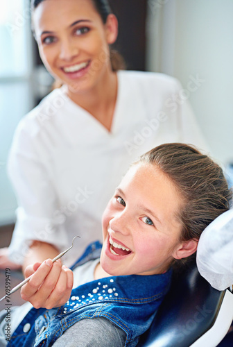 Portrait, girl and dentist with kid, woman and appointment for medical procedure and oral health. Face, professional and child with employee and dental hygiene with care and trust with consultation