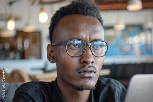 Portrait of a young handsome African businessman wearing glasses and a shirt. 