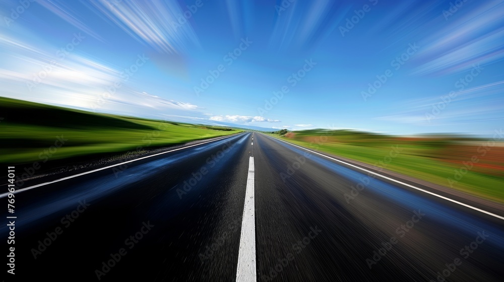 A blurry shot of a road with a blue sky in the background