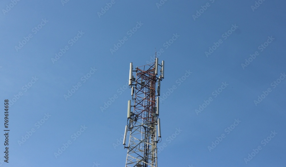 Signal tower on blue sky background. Telecommunication tower