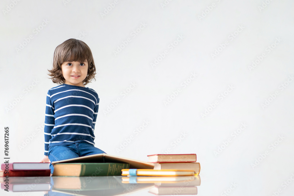 Education and back to school concept. Portrait of Happy little kindergarten child boy learning to read a book on the floor. Preschool children kids enjoy and fun study and doing homework at home. Education and back to school concept. Portrait of Happy little kindergarten child boy learning to read a book on the floor. Preschool children kids enjoy and fun study and doing homework at home.