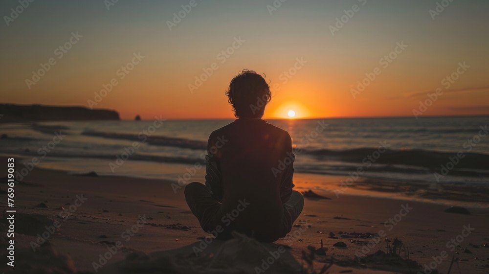 Fototapeta premium Person Enjoying a sunset from a simple, quiet beach