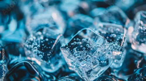 Close-up view of a cluster of ice cubes melting, with water droplets forming on their surfaces © tashechka