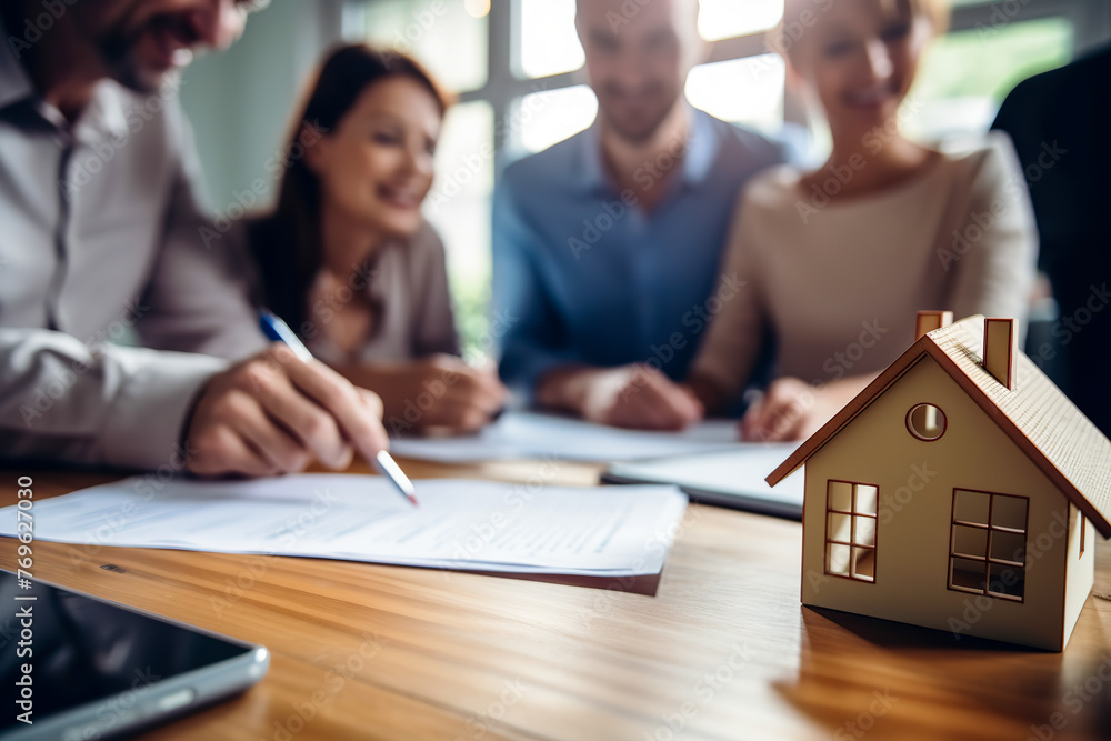 Real estate agent and clients discussing real estate purchase contract terms, insurance or home loan. Concept of mortgage Real estate agent and clients discussing real estate purchase contract terms, insurance or home loan. Concept of mortgage