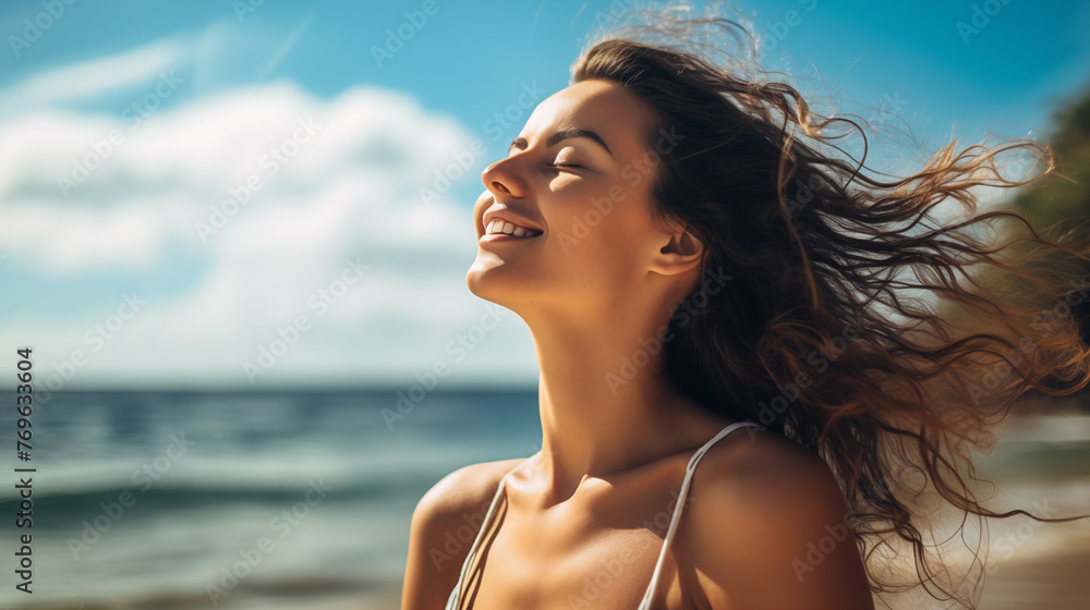 Beautiful happy woman with eyes closed and smile on amazing beach, wind playing with hair. Breathing deep, dreaming, meditation. Enjoy life, feel freedom. Summer vacation concept Beautiful happy woman with eyes closed and smile on amazing beach, wind playing with hair. Breathing deep, dreaming, meditation. Enjoy life, feel freedom. Summer vacation concept