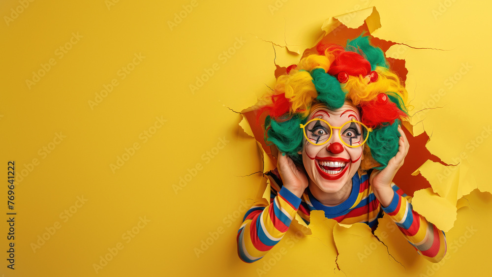 A clown in a multicolored outfit screams in excitement, breaking through a yellow paper tear with a joyous demeanor A clown in a multicolored outfit screams in excitement, breaking through a yellow paper tear with a joyous demeanor