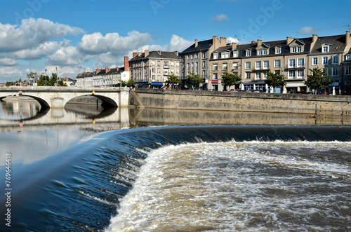 Little waterfall on the river Mayenne at Laval and the old bridge, commune in the Mayenne department in north-western France
