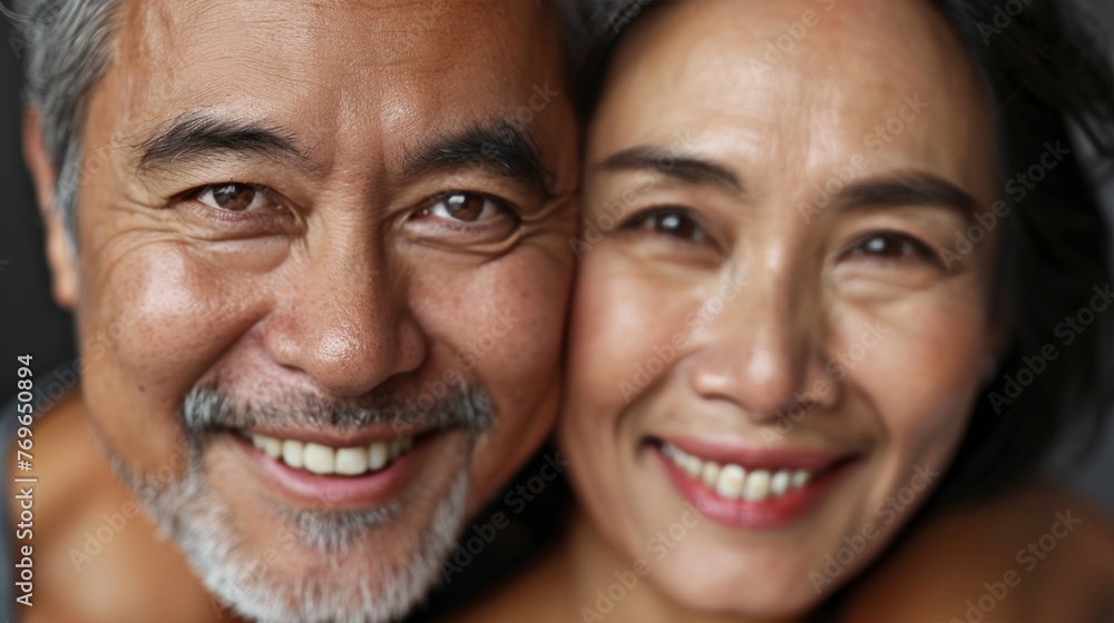 A close-up of two smiling Asian individuals likely a cou ple with their faces touching showcasing their happiness and closeness. A close-up of two smiling Asian individuals likely a cou ple with their faces touching showcasing their happiness and closeness.