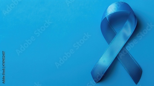 A blue awareness ribbon on a background, symbolizing various social issues. photo