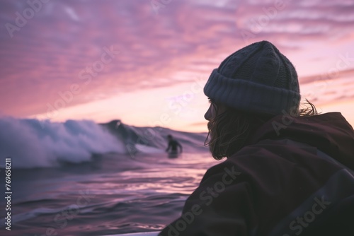 surfer in a beanie checking the waves at dawn