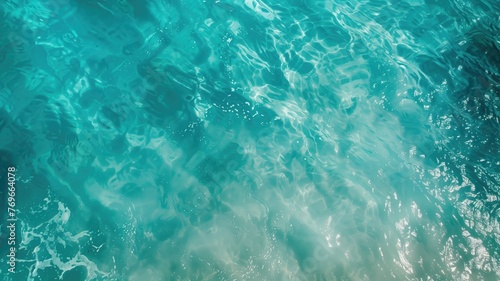 A tranquil image showing the rippling surface of clear turquoise water under sunlight.