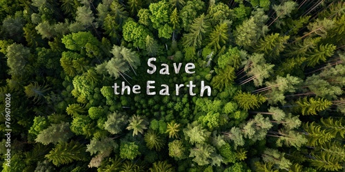 An aerial view of a forest with "Save the Earth" message spelled out in trees. 
