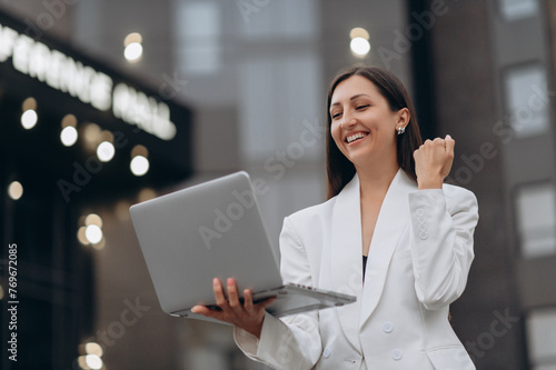 Beautiful young female celebrate with laptop, success happy pose. 