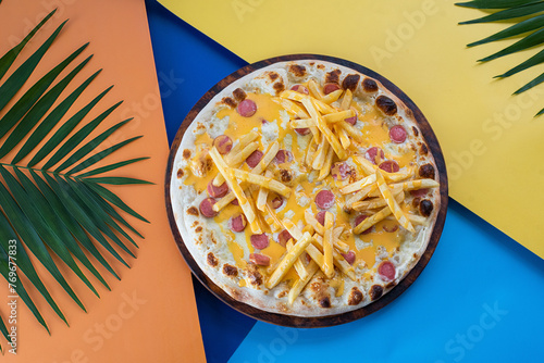 Children's pizza on a colored background of different colors with french fries and sausage