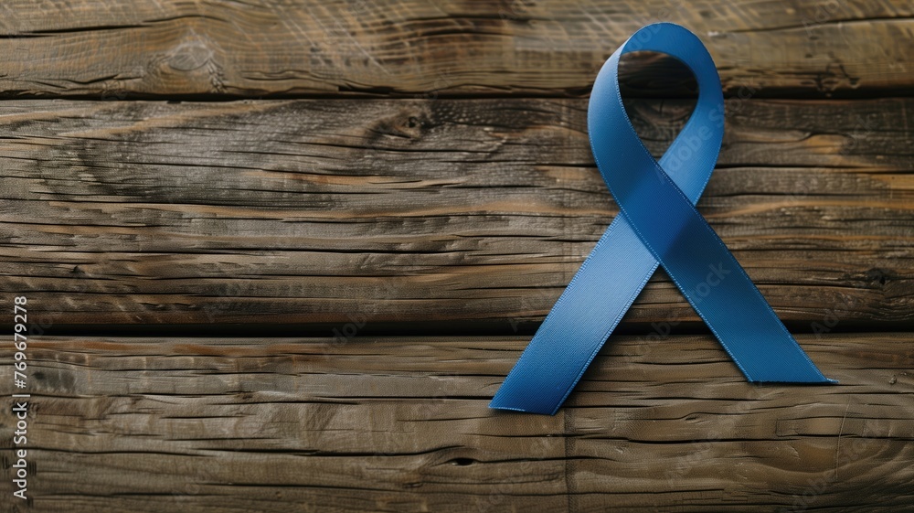 A blue ribbon on a rustic wooden background, symbolizing awareness for various causes. - obrazy, fototapety, plakaty 