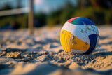 A beach volleyball ball in the sand