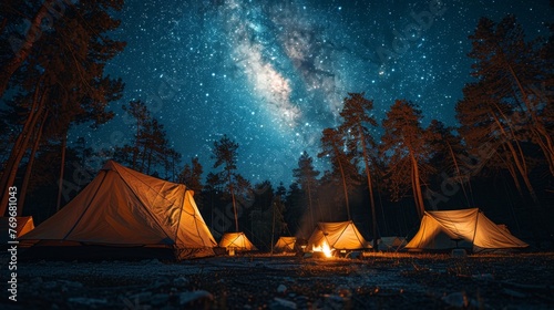 Camping under the Stars: A cozy campsite under a starry night sky, with a crackling campfire and silhouetted tents, conveying the joy of outdoor camping.