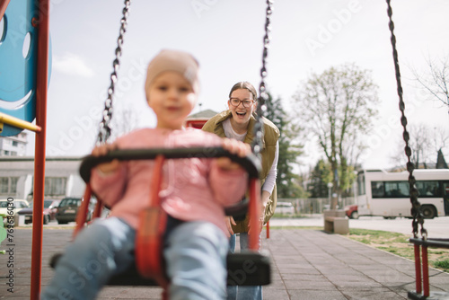 Mother and daughter on the swing