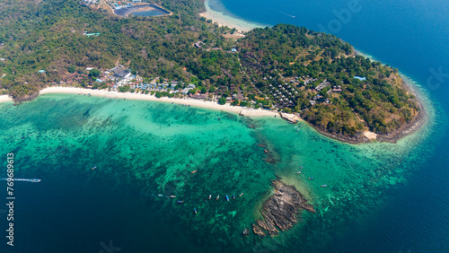 Fototapeta Naklejka Na Ścianę i Meble -  Long beach and Blacktip Reef Shark Point, Phi Phi island, Krabi, Thailand. Aerial view of a tropical island surrounded by coral reef. 