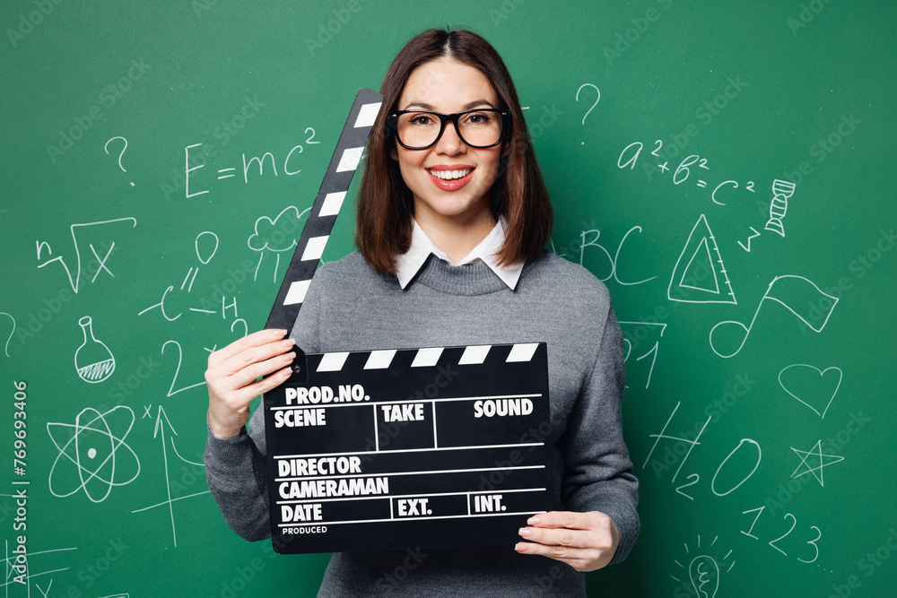 Φωτογραφία Young smart teacher woman in grey casual shirt glasses hold in hand classic blac