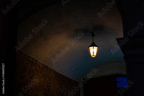 Romantic, soft candlelight illuminating a beautiful stone archway surrounded by a rustic brick wall