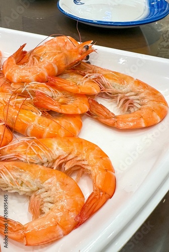 fresh shrimp sitting on a plate ready to be cooked in the kitchen