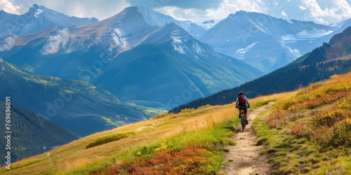 A person riding a bicycle along a scenic mountain trail. 