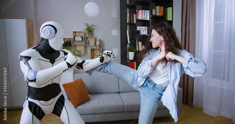 Ταπετσαρία Caucasian woman imitating punches with humanoid cyborg while practicing boxing in living room