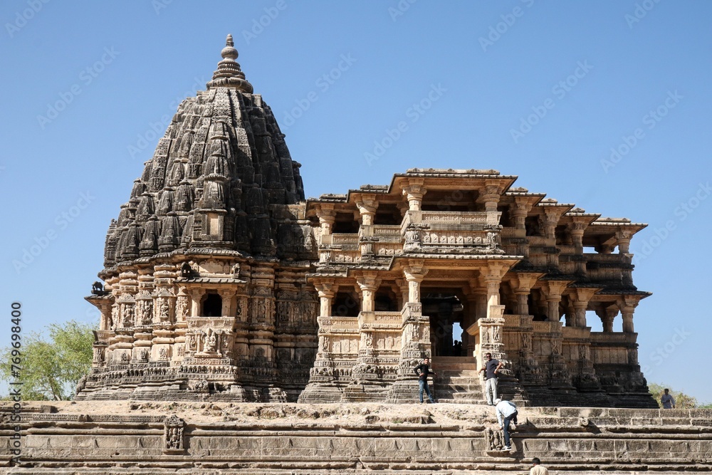 Aerial view of a large, majestic building featuring a small tower and the entrance Aerial view of a large, majestic building featuring a small tower and the entrance