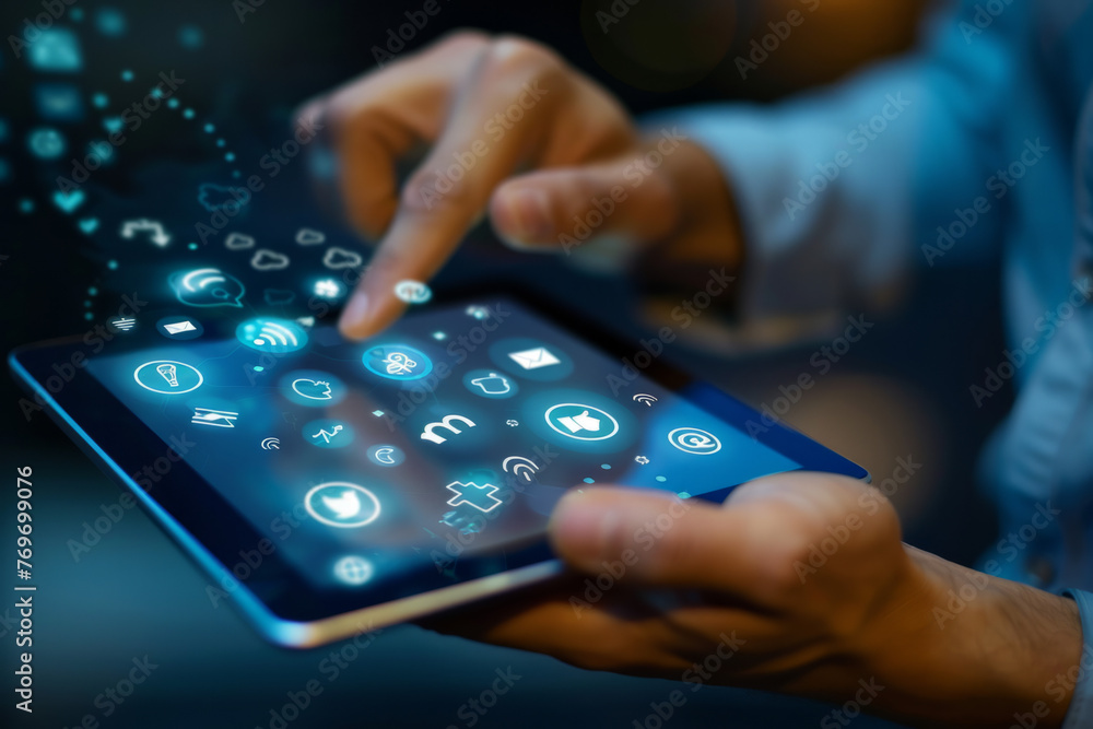 Male hands holding and touching the illuminated screen of a digital tablet with abstract communication icons on a blue background. Concept of social media Male hands holding and touching the illuminated screen of a digital tablet with abstract communication icons on a blue background. Concept of social media