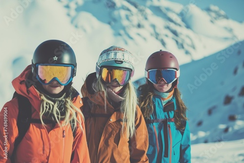 Group of young women in colorful ski gear posing in front of snow-clad mountains.