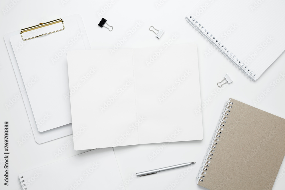 Creative flat lay mockup design of workspace. Top view composition with white notebook Creative flat lay mockup design of workspace. Top view composition with white notebook