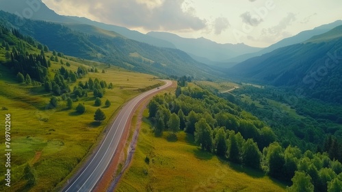 Aerial top view beautiful curve road on green forest in the rain season. © Александер Подсадник