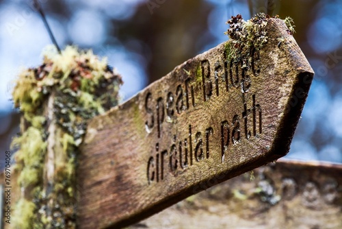 Wood sign with engraved words, 'Spean Bridge circular path' in a rustic font photo