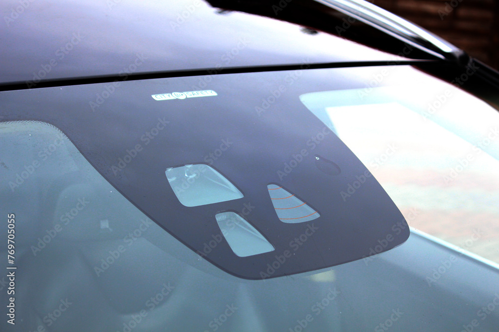 Car Active City Stop and lane keeping system. Rain and headlight