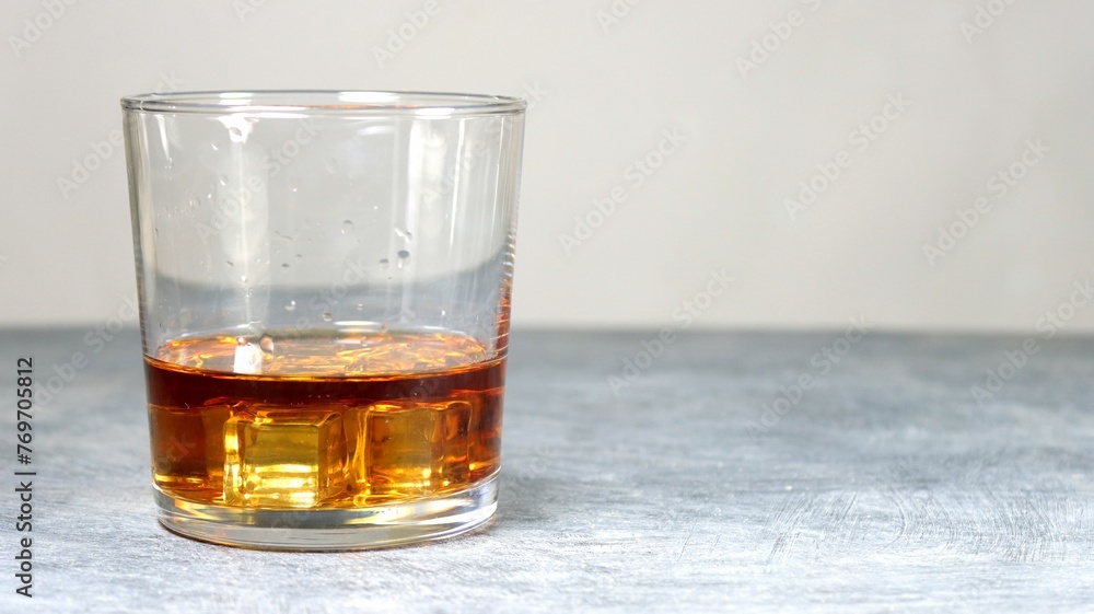 Closeup of a glass of whiskey on a table Closeup of a glass of whiskey on a table