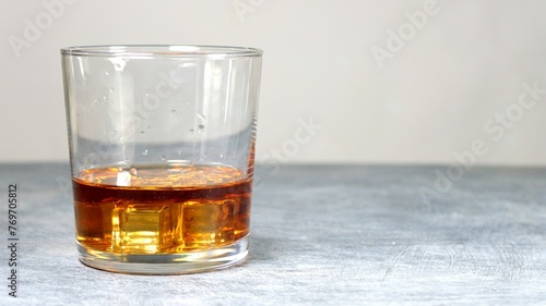 Closeup of a glass of whiskey on a table