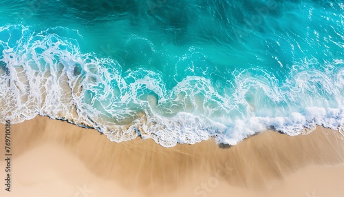 Aerial view of a tropical beach with turquoise water and white sand under the sunlight.