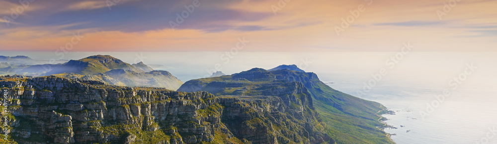 Mountain, island and clouds on sunset sky at ocean with natural landscape, hill and beach at travel banner. Nature, fog and sustainable environment with earth, sea and tropical holiday destination