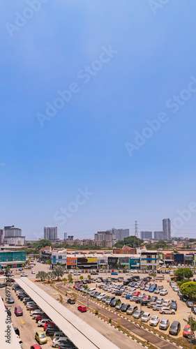 Vertical city landscape under blue sky © Niki