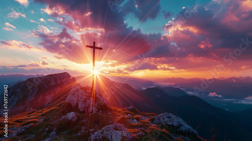 High-resolution image of a cross silhouetted against a vibrant sunset on a mountain the horizon stretching infinitely behind it