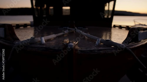 Closeup of the rope of a boat moored on the pier on the blurred background photo