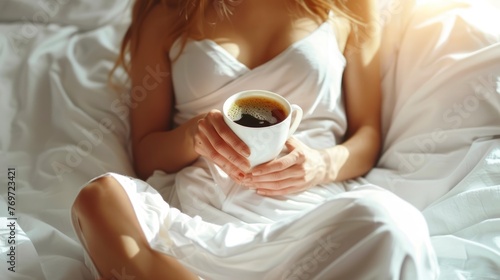 Moment a Fit Young Woman Savors Her Morning Coffee in a Big Bed with Fresh White Sheets