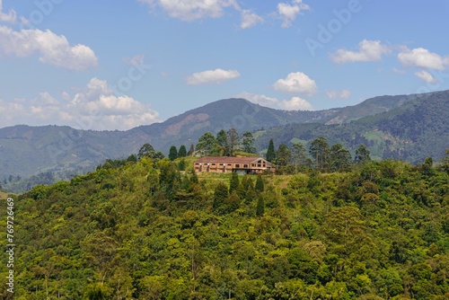 Brick and Tile House Amidst Majestic Mountain Range